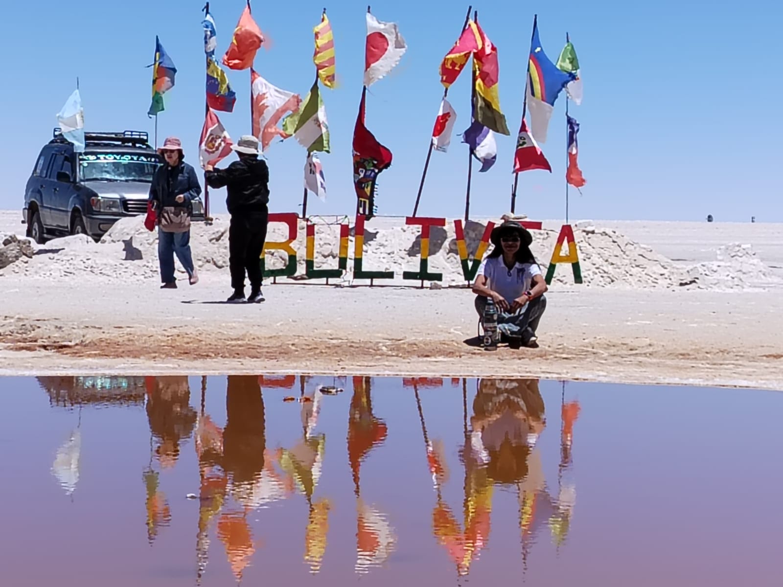Reflejo de la palabra Bolivia y las banderas en el agua